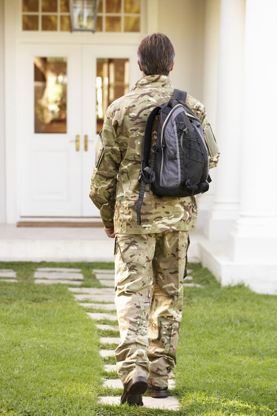 Picture of military man walking to house with backpack