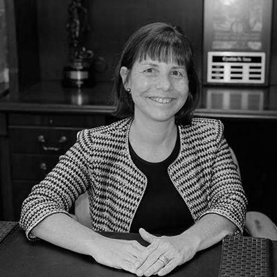 Picture of Employee Rights Attorney Cynthia Sass of Sass Law Firm siting at her desk