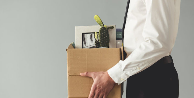 Sass Employment blog Getting fired. Cropped image of worker holding a box with his stuff, on