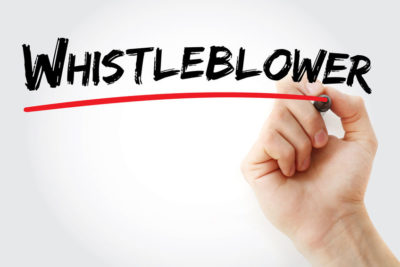 Sass law firm blog white board with black letters spelling whistleblower with a hand drawing a red underline