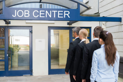 Sass Law Firm Blog: People in suits lined up in from of Job Center 