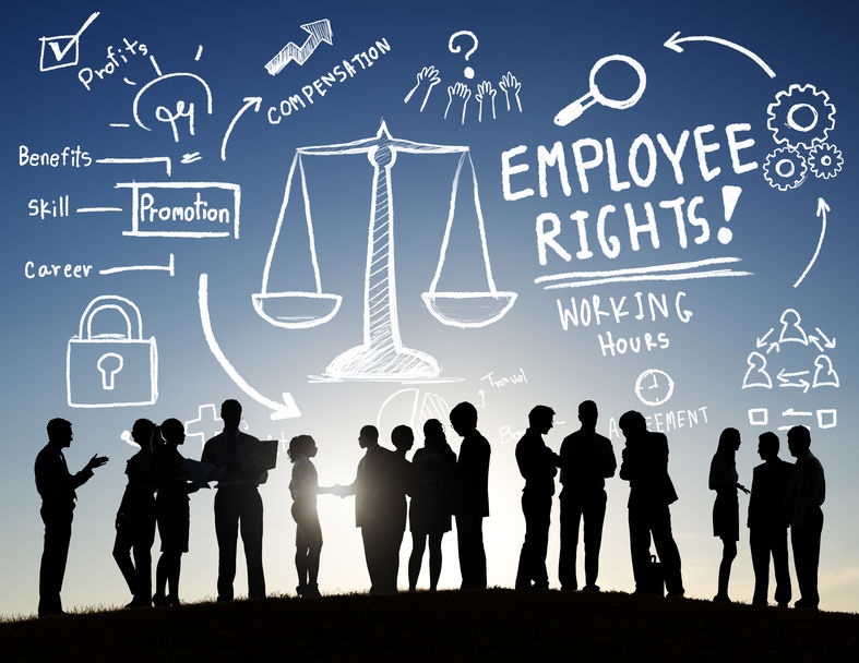Picture of silhouettes of people with chalk righting in the sky above them about employee rights