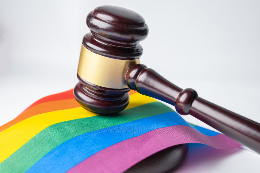 Picture of rainbow colored flag under a gavel