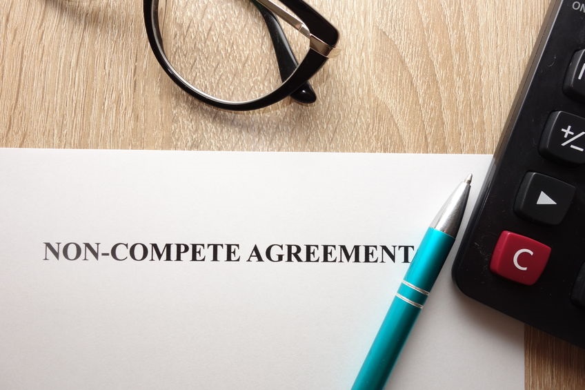 Picture of Non-Compete Agreement on a desk with eyeglasses and pen