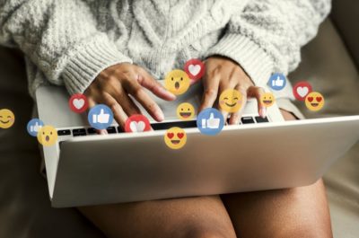 Sass Law Blog Fired For Social Media Post portraying woman's hands at a computer with social media icons all around