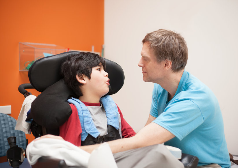 Sass Law Firm Blog Caregiver Discrimination Picture of Father Looking at Disabled Son in Wheelchair