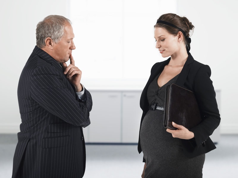 picture of an older man looking disapprovingly at the belly of a pregnant woman PREGNANCY DISCRIMINATION