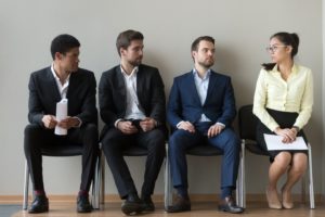picture of 3 men and 1 woman waiting to be interviewed SEX AND GENDER DISCRIMINATION